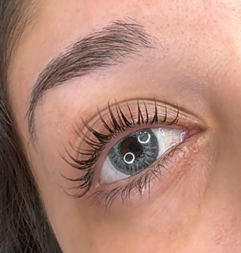 Close-up of enhanced natural eyelashes after lash lift with jet black tint – Coastal Glo Med Spa
